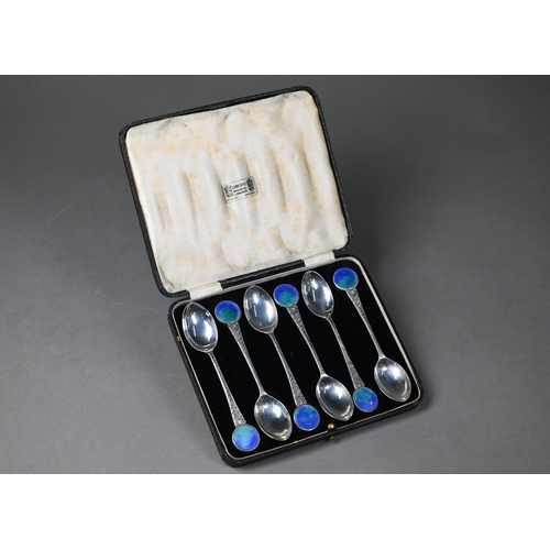 179 - A cased set of six silver teaspoons with opalescent enamel roundel finials and stylised foliate stem... 