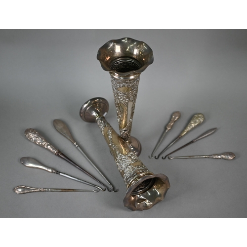 18 - A large pair of Edwardian silver vase-flutes with embossed and chased decoration and weighted bases,... 