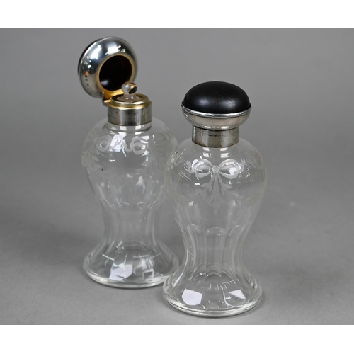 19 - A pair of cut glass cologne bottles of waisted form with wheel-etched swags, with silver and tortois... 