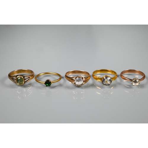 213 - Five yellow metal rings, each set with coloured gemstones including white sapphire, all unmarked and... 