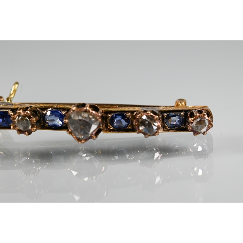 217 - An antique sapphire and diamond bar brooch with four cushion shaped sapphires and five rose cut diam... 