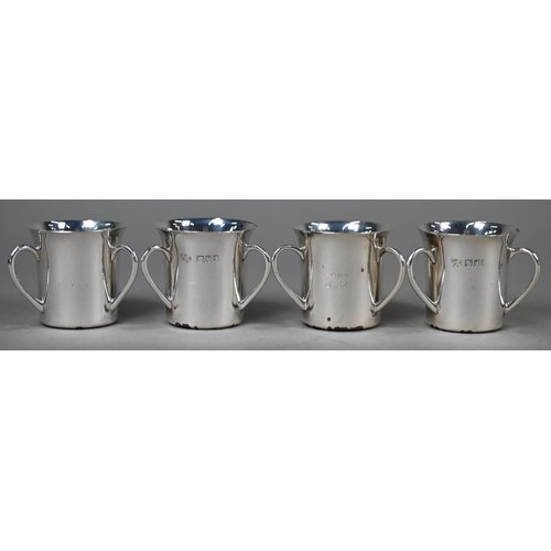 23 - An Edwardian set of six silver shot-beakers, modelled as miniature three-handled loving cups, Goldsm... 