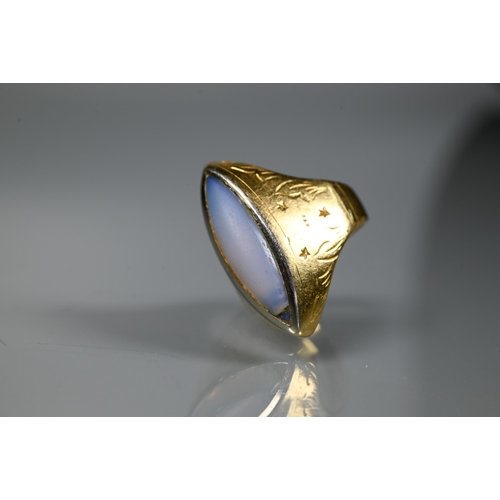 230 - A contemporary style ring with closed back elliptical moonstone (rubbed) in yellow metal setting sta... 