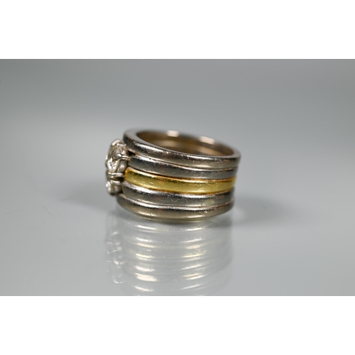 232 - A diamond set ring, the contemporary designed ring formed of a central 18ct gold band with two white... 