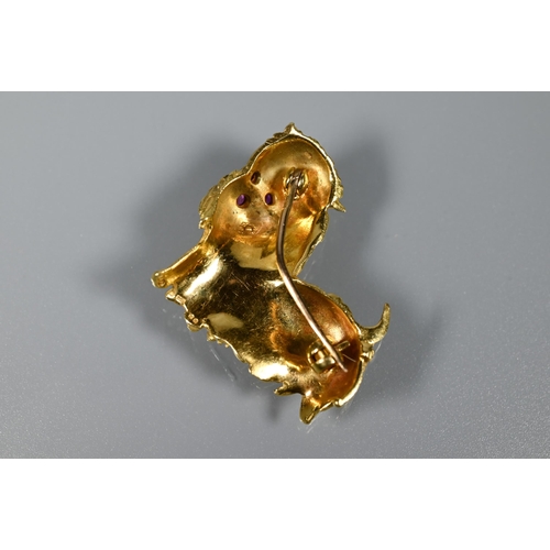 238 - An 18ct yellow gold brooch in the form of a Pekinese dog, with ruby-set eyes and nose, 3 cm long, 10... 