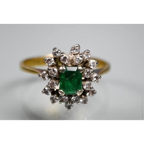 253 - An emerald and diamond cluster ring, the central rectangular emerald surrounded by twenty small diam... 