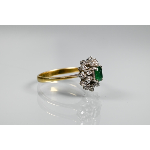 253 - An emerald and diamond cluster ring, the central rectangular emerald surrounded by twenty small diam... 