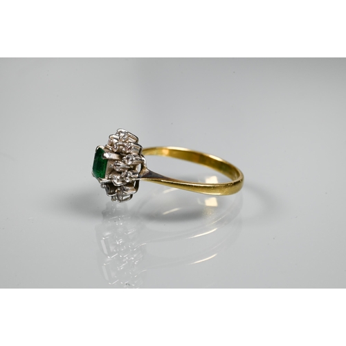 253 - An emerald and diamond cluster ring, the central rectangular emerald surrounded by twenty small diam... 