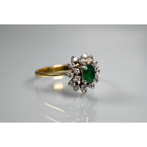 253 - An emerald and diamond cluster ring, the central rectangular emerald surrounded by twenty small diam... 