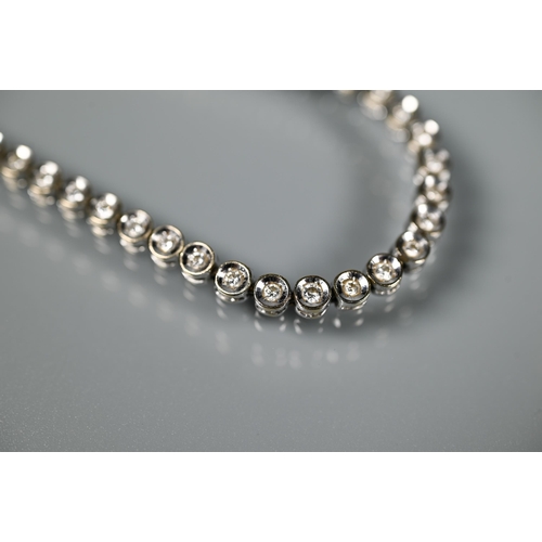 256 - A diamond line bracelet formed of fifty-two collet-set diamonds, white metal stamped 750, concealed ... 