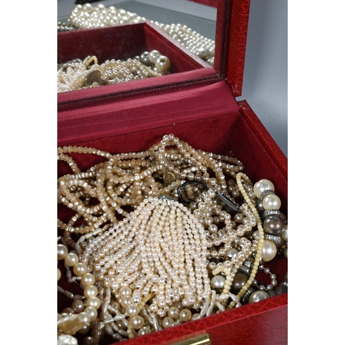 270 - A jewel box including a quantity of various simulated and cultured pearls