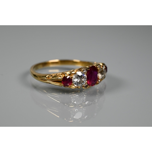 277 - An antique ruby and diamond ring, the three rubies with a briliant diamond to each side and diamond ... 