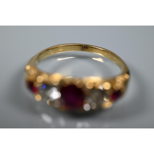 277 - An antique ruby and diamond ring, the three rubies with a briliant diamond to each side and diamond ... 