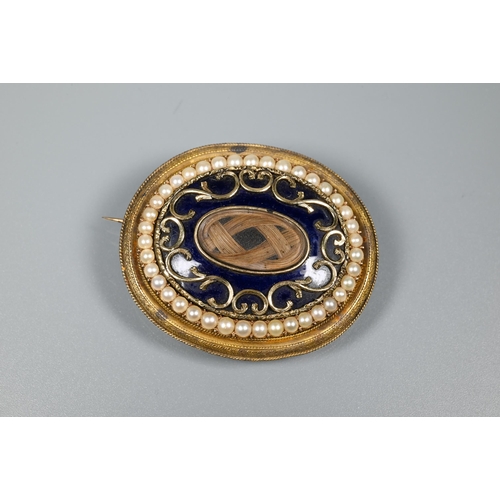 279 - A Victorian oval mourning brooch featuring plaited hairwork to front and back, the oval blue enamel ... 