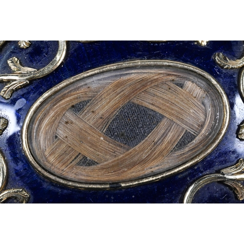 279 - A Victorian oval mourning brooch featuring plaited hairwork to front and back, the oval blue enamel ... 