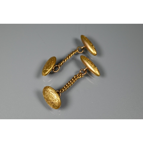 283 - A pair of 15ct yellow gold chased cufflinks, chain-linked with oval front and torpedo back, 6.1g, a ... 