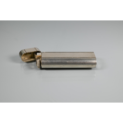 318 - Cartier - A silver-plated lighter of flattened cylindrical form, 7 x 2.5 cm