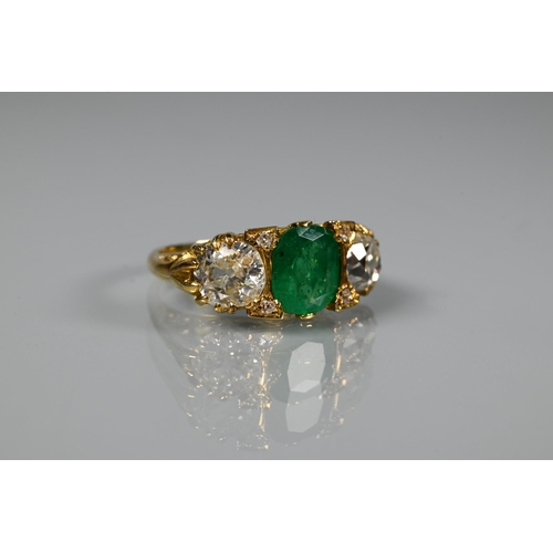 320 - An early 20th century ring with central cushion cut natural emerald with brilliant cut diamond to ea... 