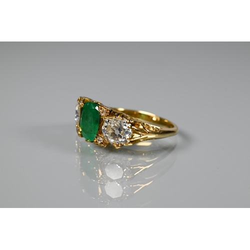 320 - An early 20th century ring with central cushion cut natural emerald with brilliant cut diamond to ea... 