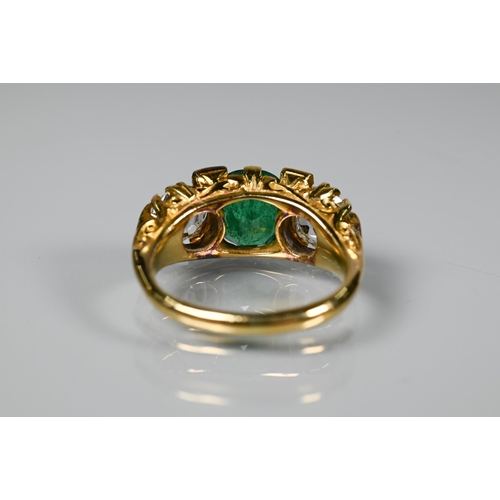 320 - An early 20th century ring with central cushion cut natural emerald with brilliant cut diamond to ea... 