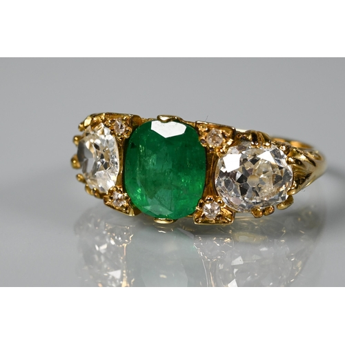 320 - An early 20th century ring with central cushion cut natural emerald with brilliant cut diamond to ea... 