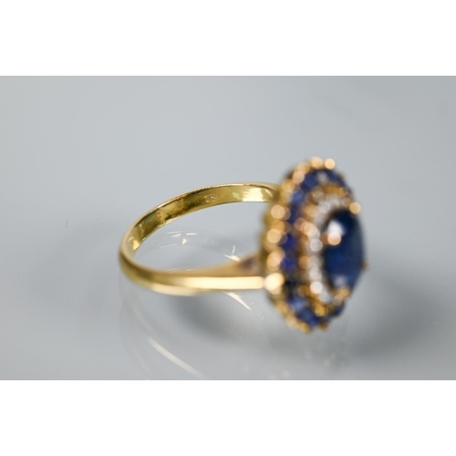 325 - A sapphire and diamond cluster ring, the central natural sapphire with two rows of diamonds and sapp... 