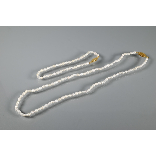 333 - A river pearl necklace and bracelet, a gilt metal brooch in the form of a leaf with single matching ... 