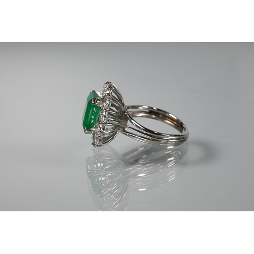 335 - A rectangular cluster ring, the central natural emerald surrounded by twelve brilliant cut diamonds,... 