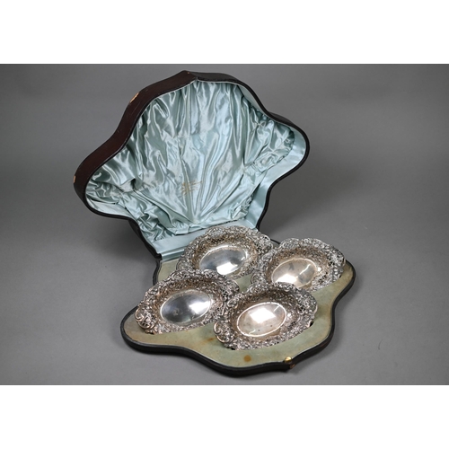 35 - A late Victorian cased set of four embossed, chased and pierced silver bonbon dishes, Henry Matthews... 