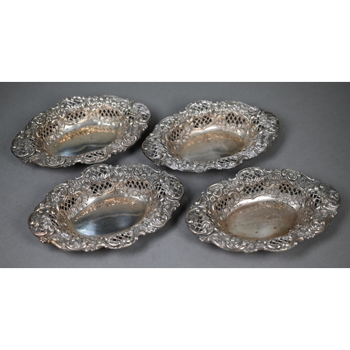 35 - A late Victorian cased set of four embossed, chased and pierced silver bonbon dishes, Henry Matthews... 