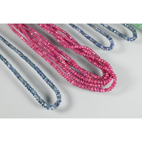 353 - A five strand rough-cut ruby necklace on white metal clasp; a double row of graduated flattened emer... 