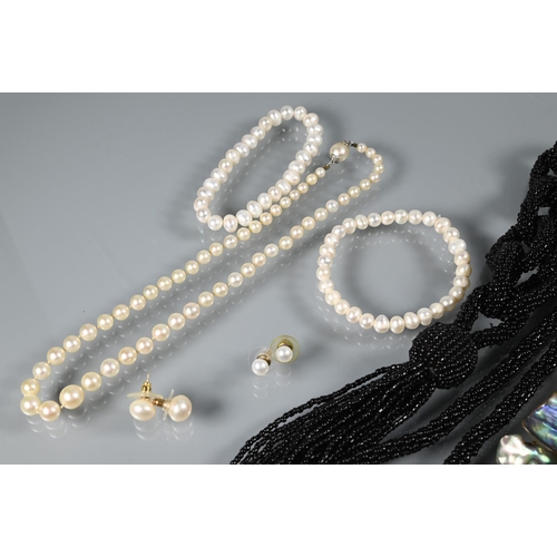 355 - A graduated cultured pearl short neckace double knotted throughout onto concealed pearl clasps, two ... 