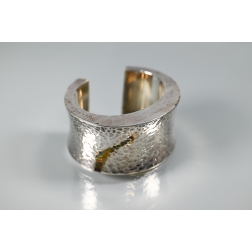 356 - Bangles - a hammered white metal open cuff stamped MEXICO, a Halcyon Days gilt, enamel and diamanté ... 