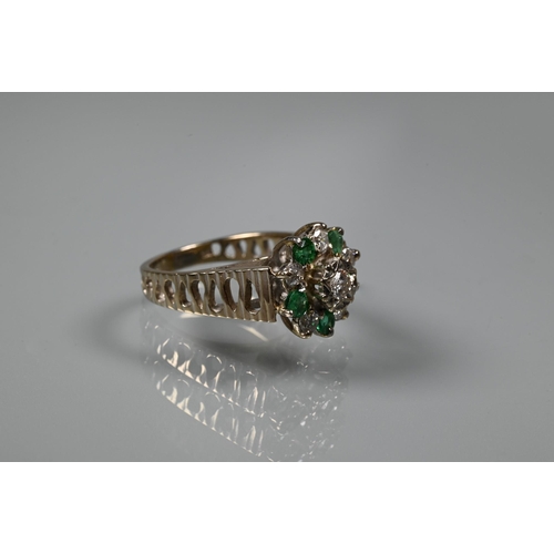 371 - A 1970s emerald and diamond cluster ring, the central bezel mounted diamond surrounded by five emera... 