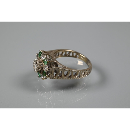 371 - A 1970s emerald and diamond cluster ring, the central bezel mounted diamond surrounded by five emera... 