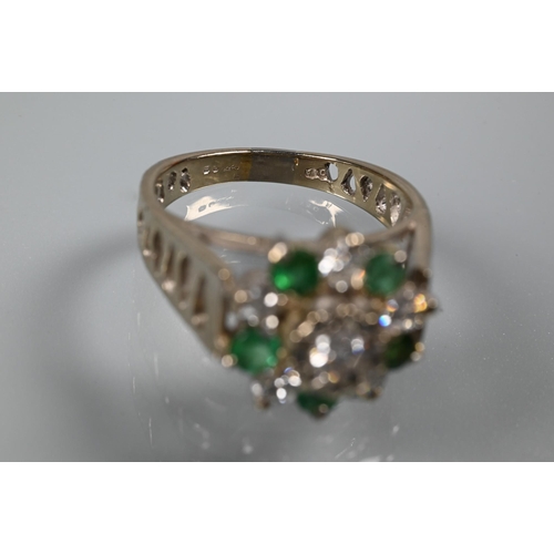 371 - A 1970s emerald and diamond cluster ring, the central bezel mounted diamond surrounded by five emera... 