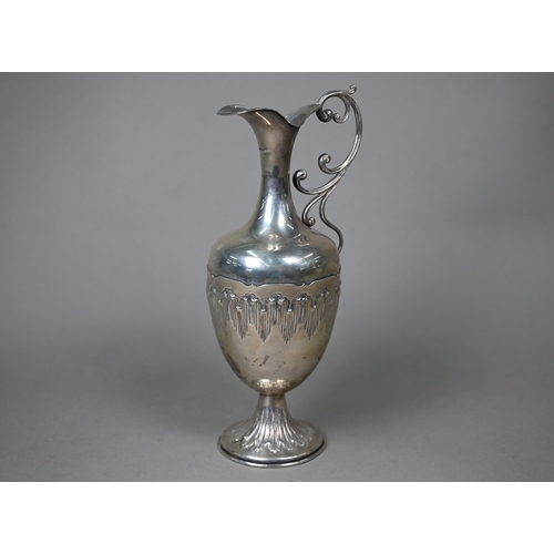 38 - A Continental white metal wine ewer of baluster form with scroll handle and weighted foot, stamped '... 