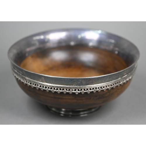 52 - Omar Ramsden: a silver-mounted turned maple wood mazer bowl, the flaring silver rim applied with ban... 