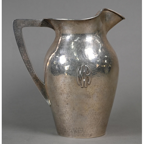 57 - A US Sterling Arts & Crafts '5 Pints' silver jug of planished ovoid form, with applied 'MR' mono... 