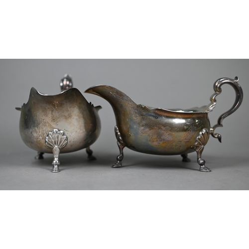 65 - A pair of heavy quality silver sauce boats in the Georgian taste, with scroll handles and hoof feet,... 
