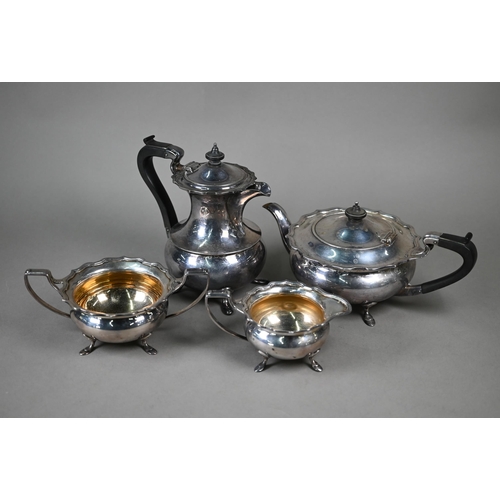 67 - A silver three-piece tea service of compressed form with moulded rims, composite mounts to teapot, E... 