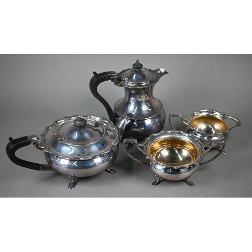 67 - A silver three-piece tea service of compressed form with moulded rims, composite mounts to teapot, E... 