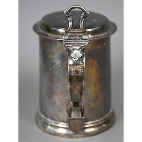 75 - A George II silver tankard of plain tapering cylindrical form, the flattened dome hinged lid with op... 