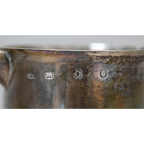 75 - A George II silver tankard of plain tapering cylindrical form, the flattened dome hinged lid with op... 