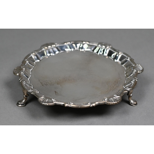 79 - An early George III silver card salver with shell and scroll moulded rim and three hoof feet, Richar... 