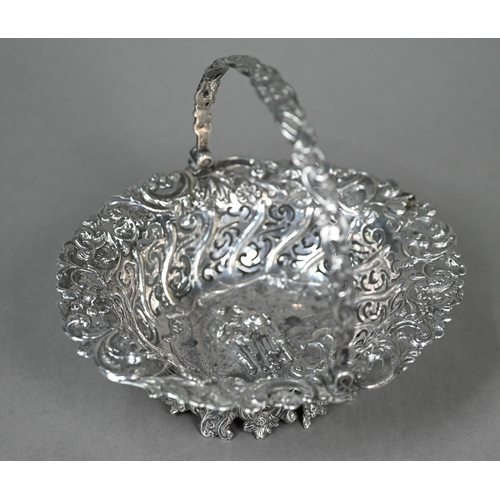 86 - A Victorian silver bonbon basket, embossed with a rustic courting couple, in decorative pierced surr... 