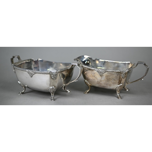 87 - A heavy quality oblong silver three-piece tea service with moulded rims and hoof feet, ebonised fini... 