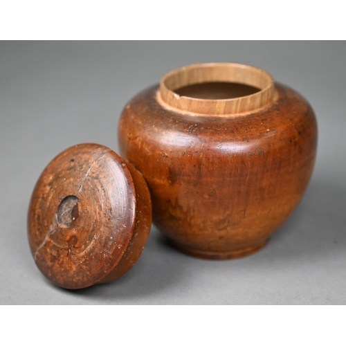 1010 - A Georgian turned wood tea caddy, modelled as an apple, 11 cm high, to/w a turned fruitwood jar and ... 