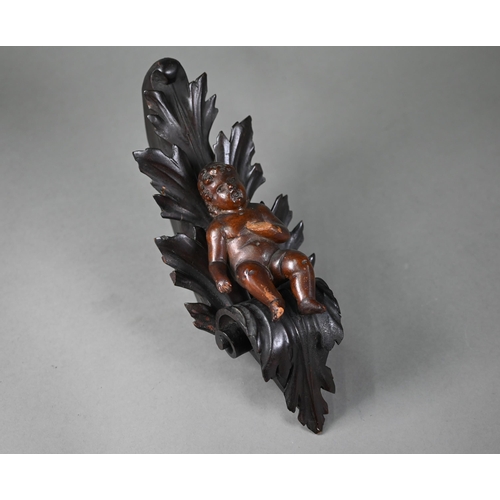 1017 - An antique (probably 17th century) carved wood putto, on scrolling foliate bracket (possibly later),... 