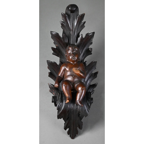 1017 - An antique (probably 17th century) carved wood putto, on scrolling foliate bracket (possibly later),... 